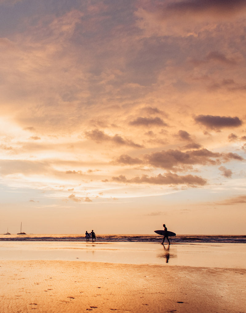 Surfers at sunset in Tamarindo Costa Rica. Photographed by Kristen M. Brown, Samba to the Sea for The Sunset Shop.