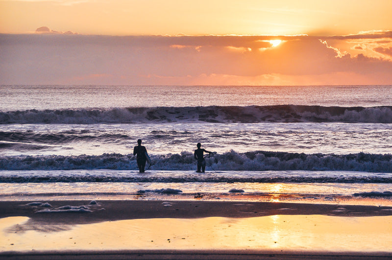 Surfer girls paddling out at Poles in Jacksonville Florida during Hurricane Maria. Edited by Kristen M. Brown, Samba to the Sea for The Sunset Shop.