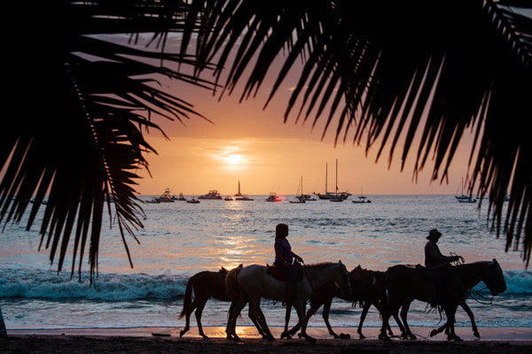 Sunset horseback ride on the beach in Tamarindo, Costa Rica. Photographed by Kristen M. Brown, Samba to the Sea for The Sunset Shop.