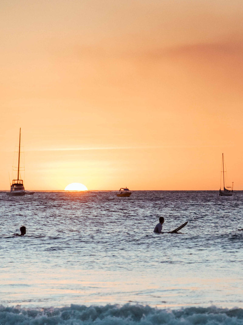 Surfers watching sunset in Tamarindo Costa Rica. Surf art pictures photographed by Kristen M. Brown, Samba to the Sea for The Sunset Shop.