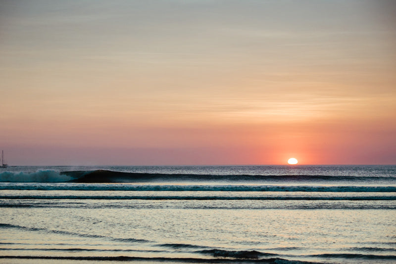 Waves breaking during sunset in Tamarindo Costa Rica. Sunset art pictures photographed by Kristen M. Brown, Samba to the Sea for The Sunset Shop.