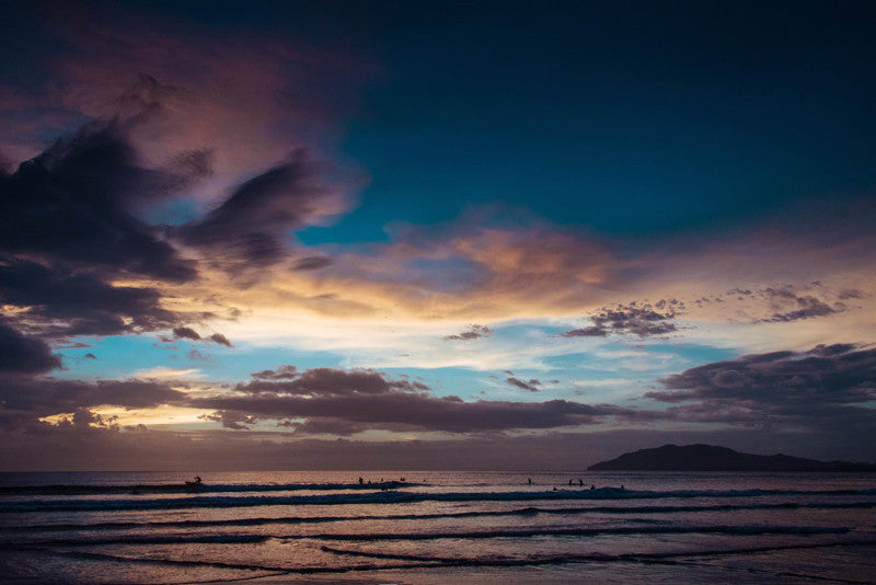 Surfers enjoying the waves at sunset in Tamarindo Costa Rica. Photographed by Kristen M. Brown, Samba to the Sea.