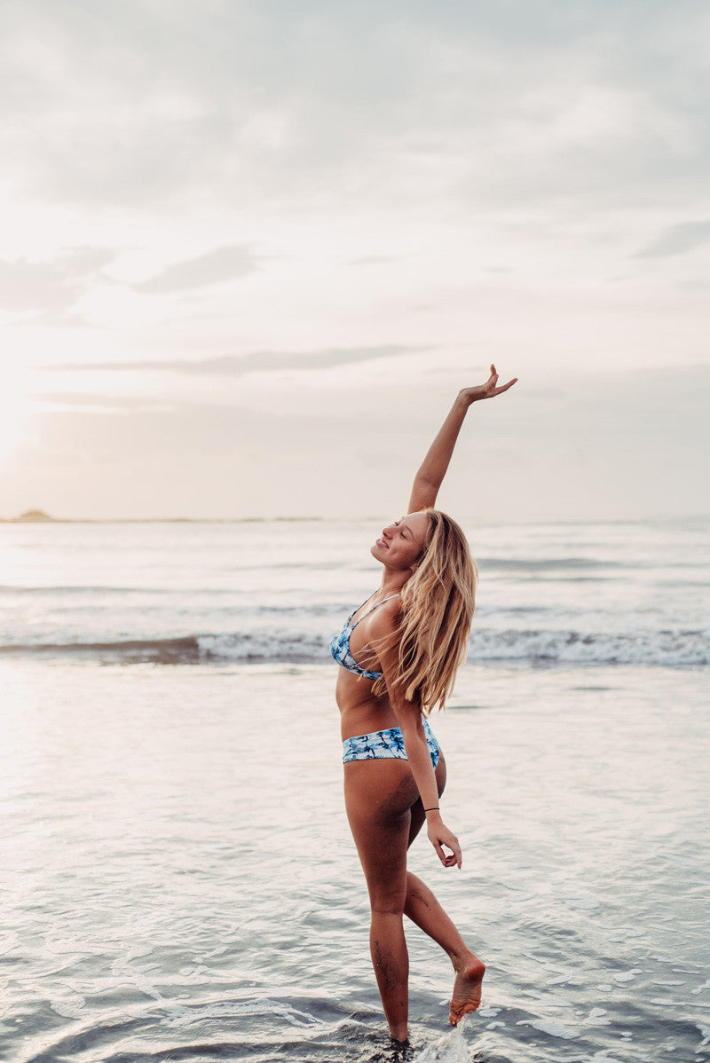 Surfer girl dancing on the beach in Tamarindo Costa Rica. Photographed by Kristen M. Brown, Samba to the Sea. 