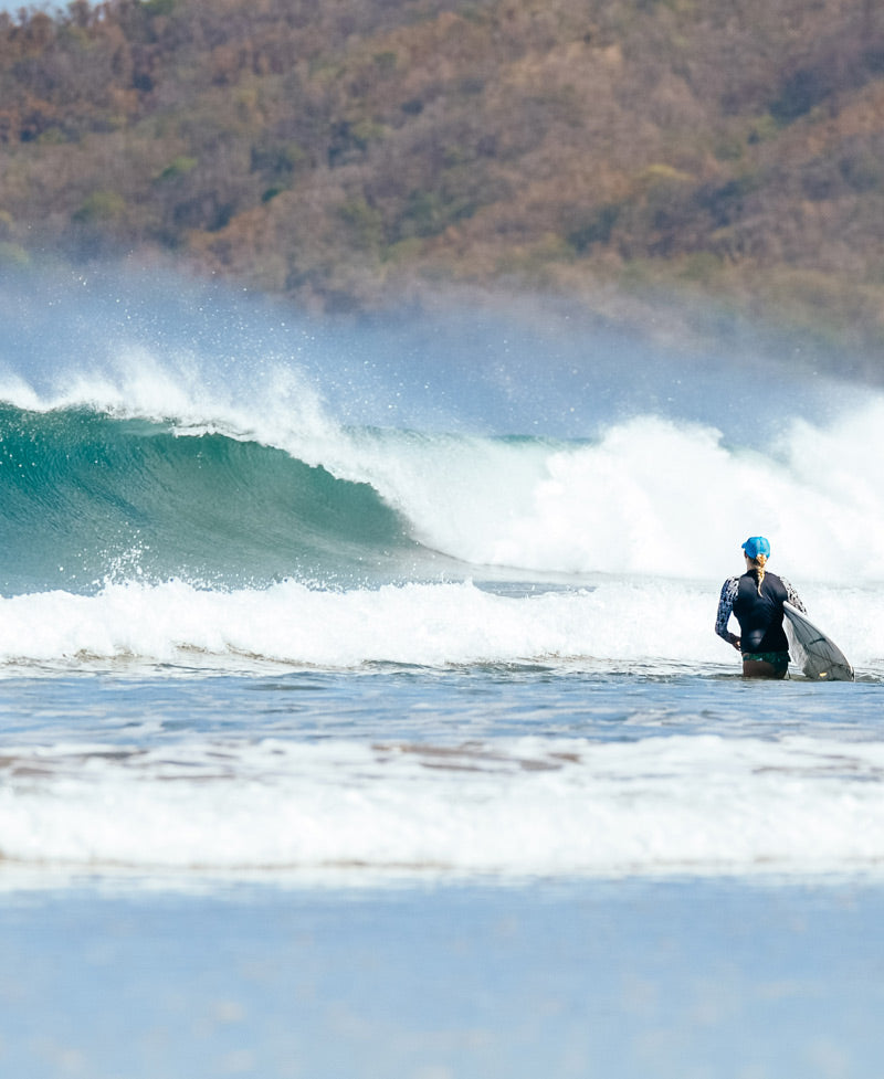 Surfer girl walking to the waves in Playa Tamarindo Costa Rica. Photographed by Kristen M. Brown, Samba to the Sea for The Sunset Shop.