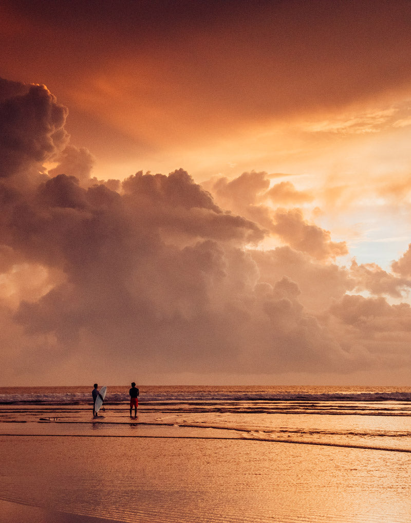 Surfers at sunset in Tamarindo Costa Rica. Photographed by Kristen M. Brown, Samba to the Sea for The Sunset Shop.