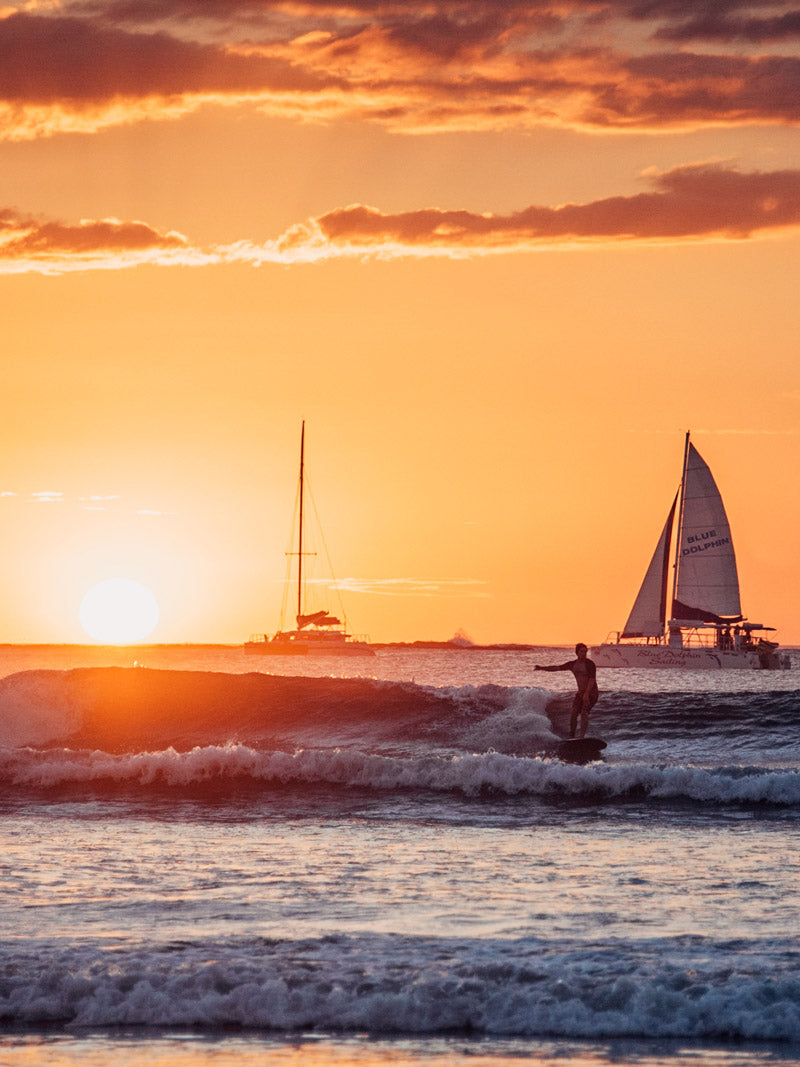 Surfing during sunset in Costa Rica. Fine art beach photography print Photographed by Kristen M. Brown, Samba to the Sea for The Sunset Shop.