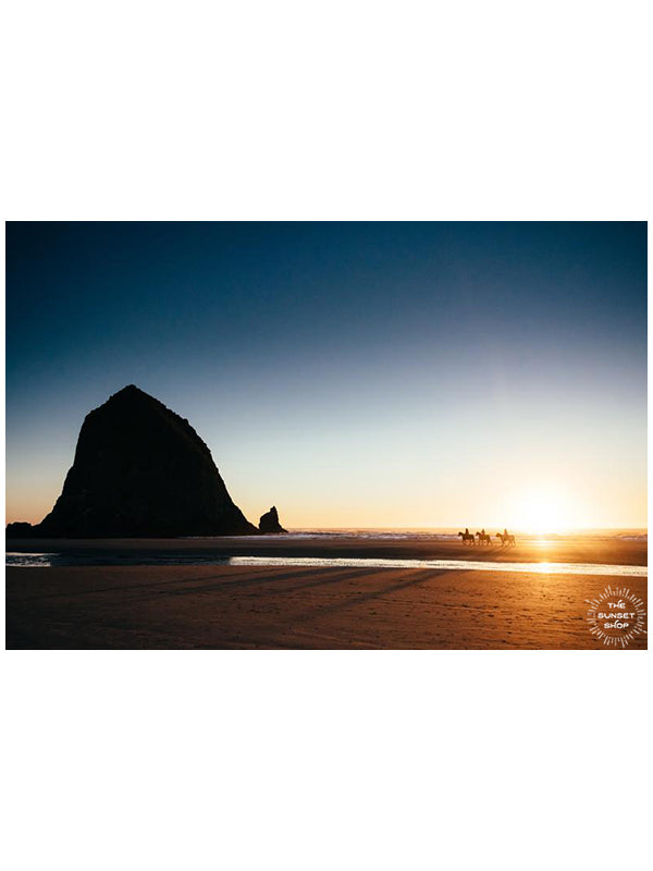 Horseback ride on the beach in Cannon Beach, Oregon during a golden sunset. Horseback riding on the beach by Haystack Rock. "Cannon Beach Gold" golden beach sunset print by Kristen M. Brown, Samba to the Sea. BUY "Cannon Beach Gold"