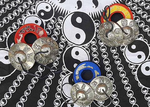 Tibetan Tingsha Bells on a Yin Yang Background