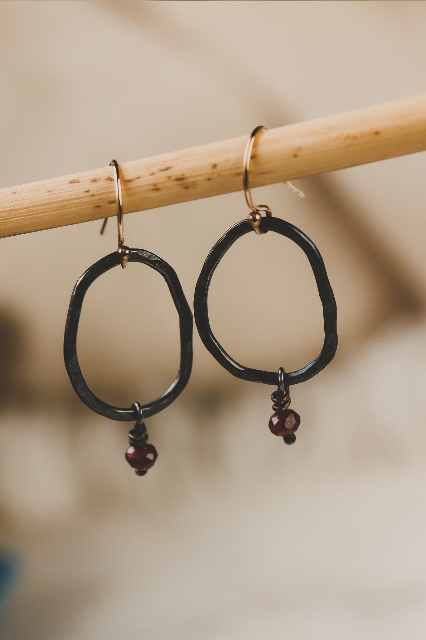 forged link earrings with garnet beads 