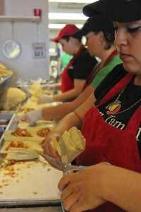 Tucson Tamale staff rolling fresh steamed tamales