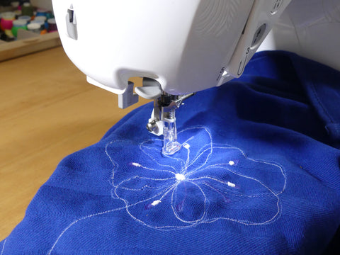 drawing a flower with a sewing machine on a tea towel