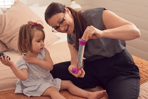 nurse showing a little girl a calming tool