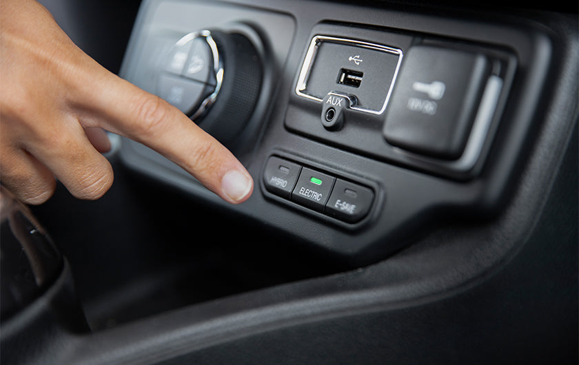 Image of a man charging his phone in the car