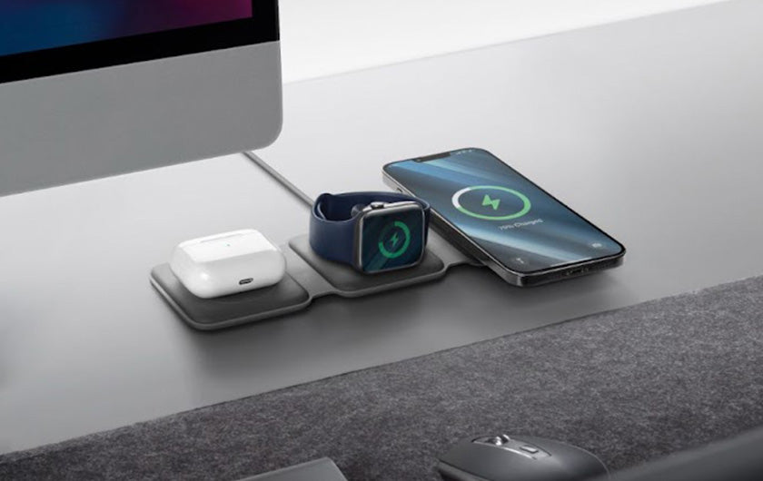 Smartphone placed on top of a wireless charger on a workdesk
