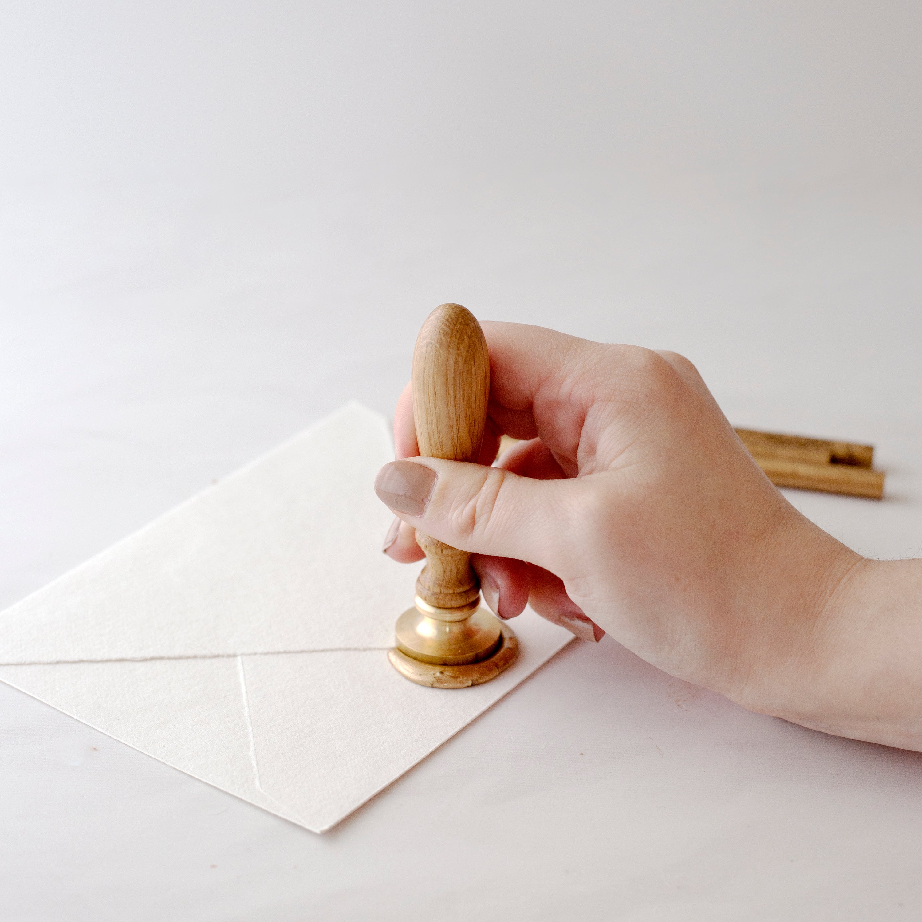 Resting Wax Seal Stamp In Sealing Wax | How To Use A Wax Seal Stamp With A Glue Gun | Heirloom Seals