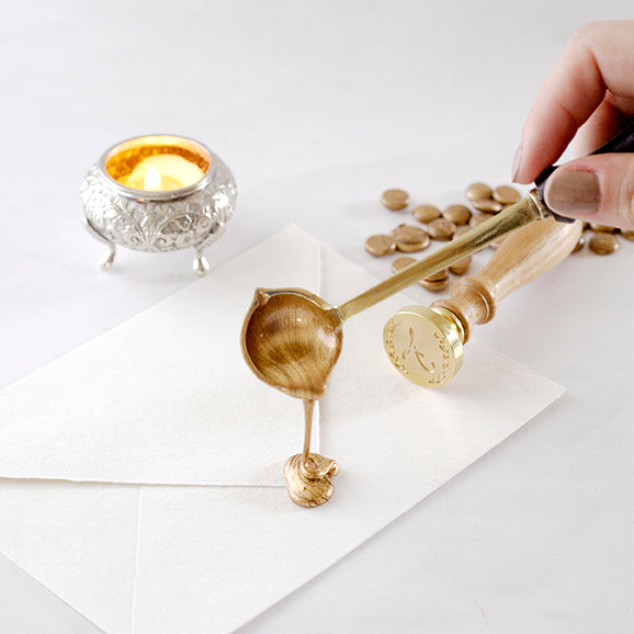 Pouring Gold Sealing Wax From A Melting Spoon Onto Envelope Flap | How To Use Sealing Wax Beads | Heirloom Seals