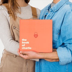 Two people holding the Book Of Everyone