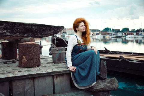 woman with red hair and green dress by Liliya Grek Unsplash.com