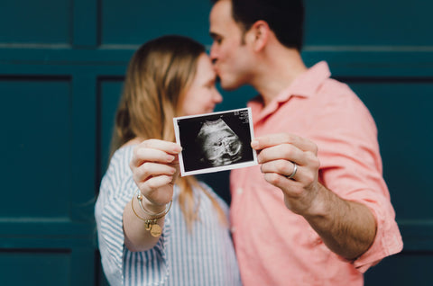 Couple holding Ultrasonography image of baby