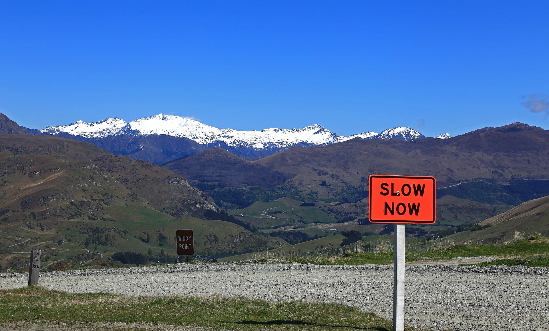 slow down sign in mountainous area