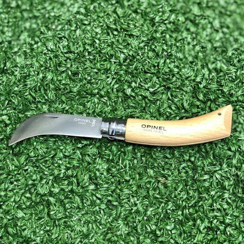 Opinel knife - multipurpose folding knife on green background