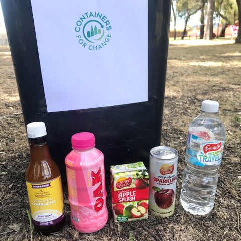 Bottles for recycling in front of a Containers for Change bin