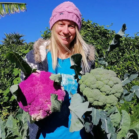 Laura Blishen from Thrive sustainability with a purple cauliflower and broccoli