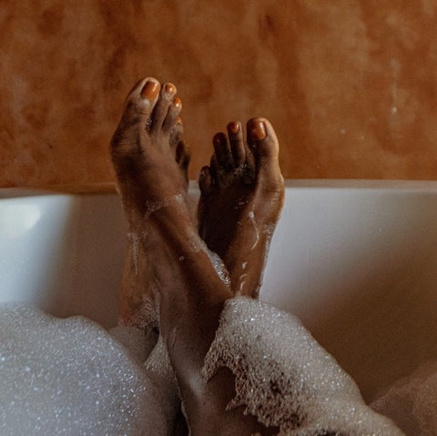 feet in bath tub with soap
