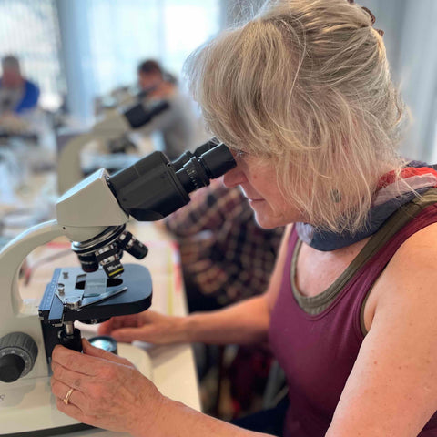 Lady looking through microscope