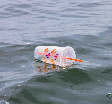 Plastic cup floating in ocean