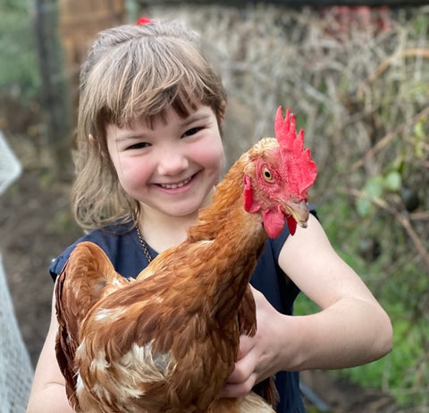 child holding brown chicken