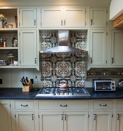 A re-imagined colorway for this Cuban pattern, focused behind the range, works well with this traditional New England Kitchen.