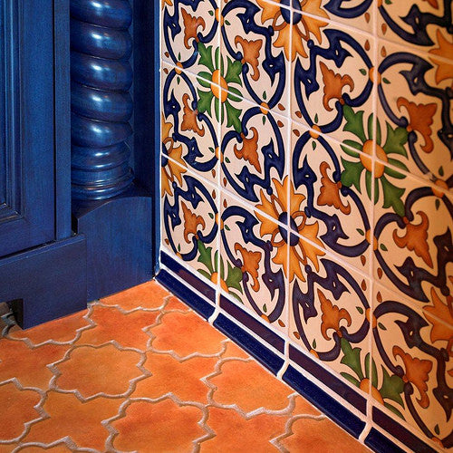 Hand-painted Spanish wall tile paired with concrete floor tile with the look of Mexican saltillo tile