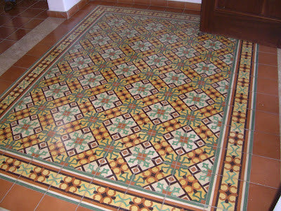 An eye-catching cement tile rug is used in this residential entry