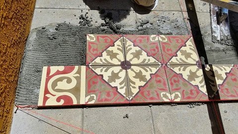 When installing a cement tile pattern or rug, start with the main field pattern in the center, then the border