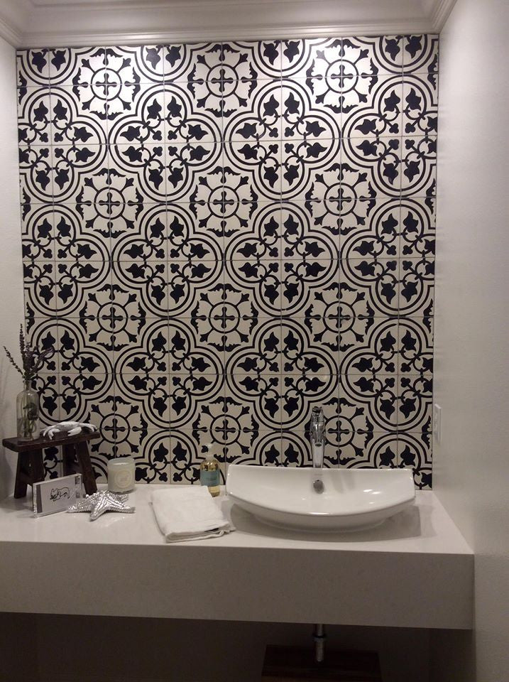 This cement tile in a classic black and white pattern makes a stunning powder room backsplash