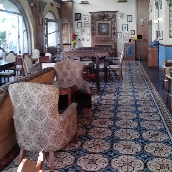 The main dining hall at Perch features a classic cement tile rug that runs the expanse of the room