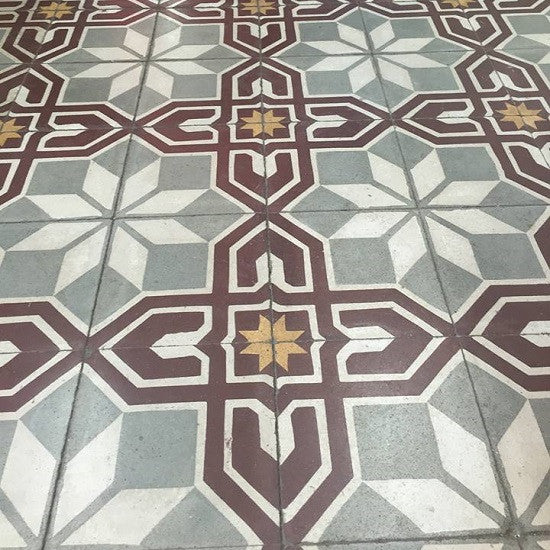Cuban cement tile patterns use floral or geometric motifs, like the one shown here