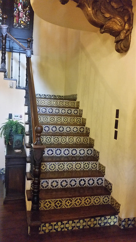 A grand staircase with Spanish tile and tile floor molding in La Casa Nueva