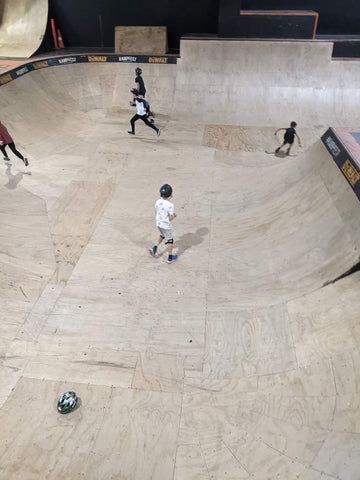 RampSchool students scouring the bowl for any hidden Easter Eggs during the egg hunt at Rampfest Indoor Skatepark
