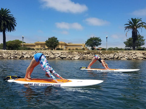 Two yogis practicing yoga on steady water