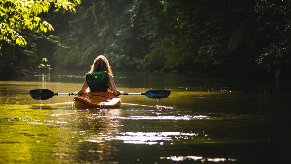 Kayaker on a sunlit river