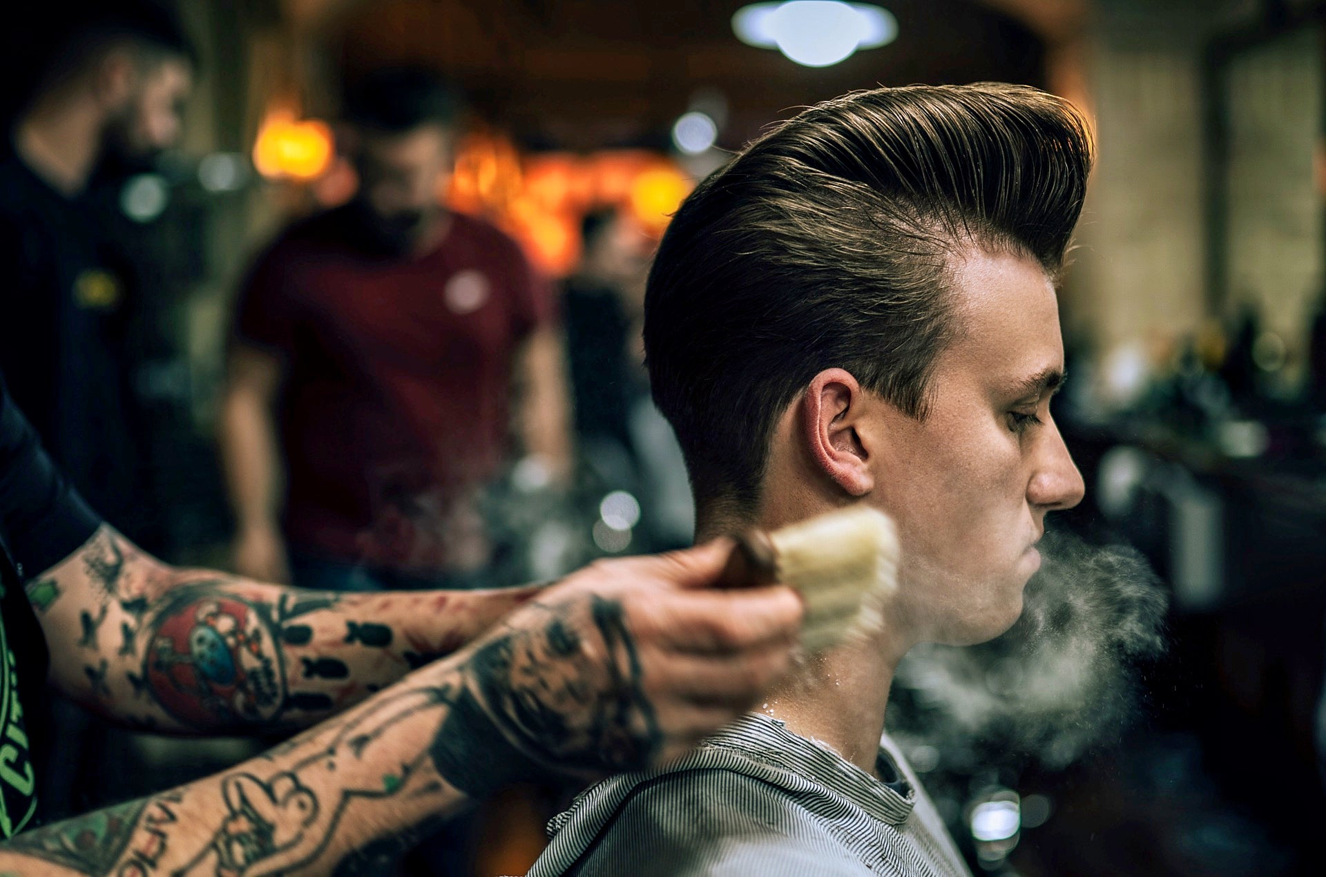 Stylish guy with a fresh haircut sporting a classic pomp hairstyle. (Photo by André Reis on Unsplash)