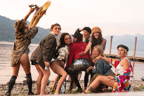 Girls at a hen party wearing black silver sequin flared trousers