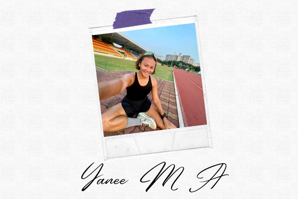 Yanee sitting on the track ground on a sunny morning in running gear, smiling at the camera