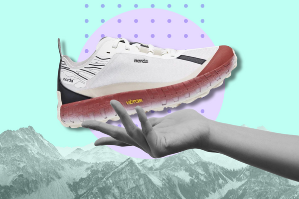 image of a hand holding up a Norda 001 trail running shoe with mountains in the graphically-rendered background