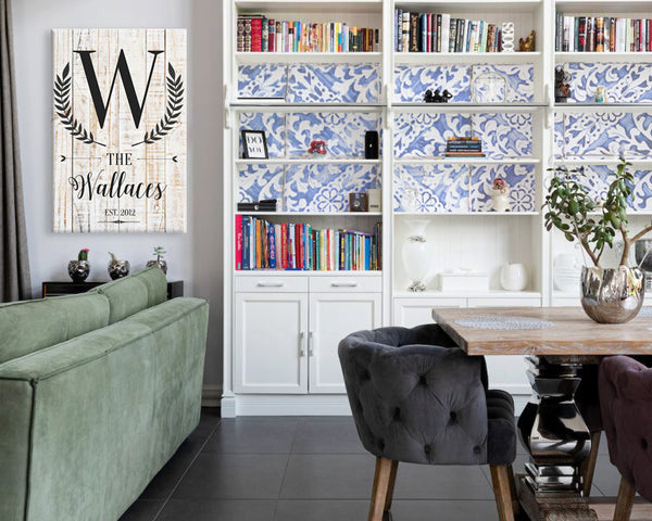 living room with bookshelf with family name wall art - Gear Den
