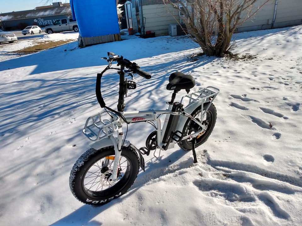 A DJ Folding Bike fat tire e-bike on snowy ground