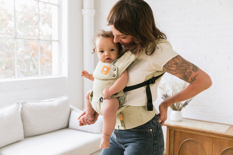 A soft-structured buckle carrier, used by a mother.