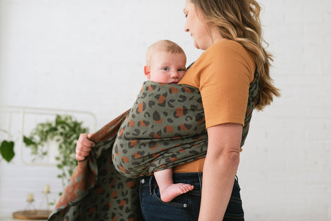 A baby sitting well in a Tula Ring Sling.